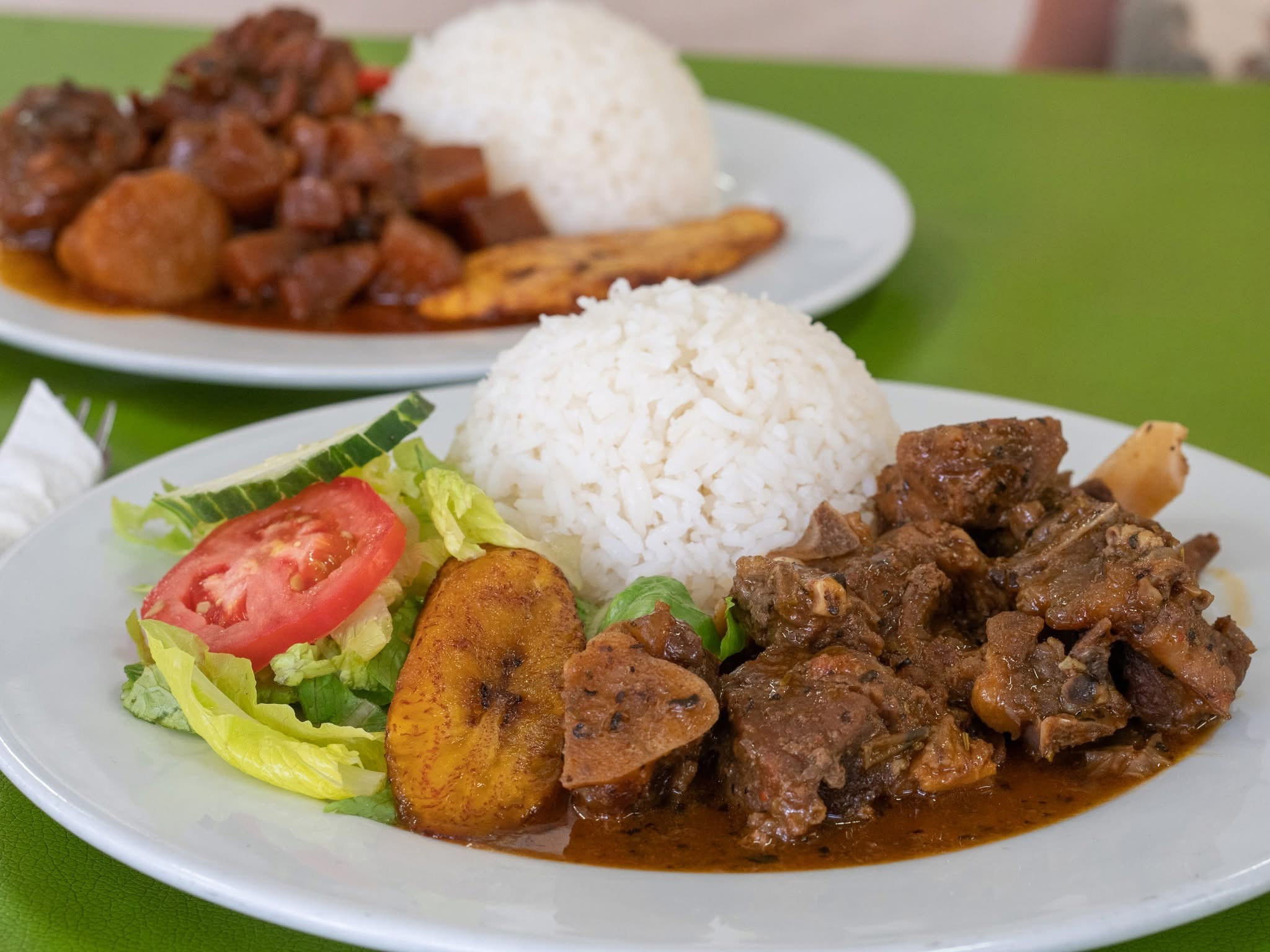 A plate of Curaçao home cooking with rice and plantain